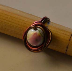 Anillo marrón y rosa con bola con flor